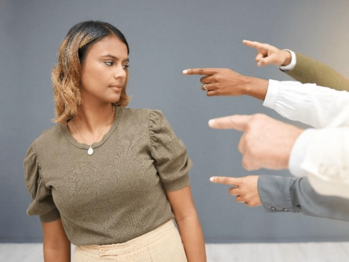 Woman being pointed at.